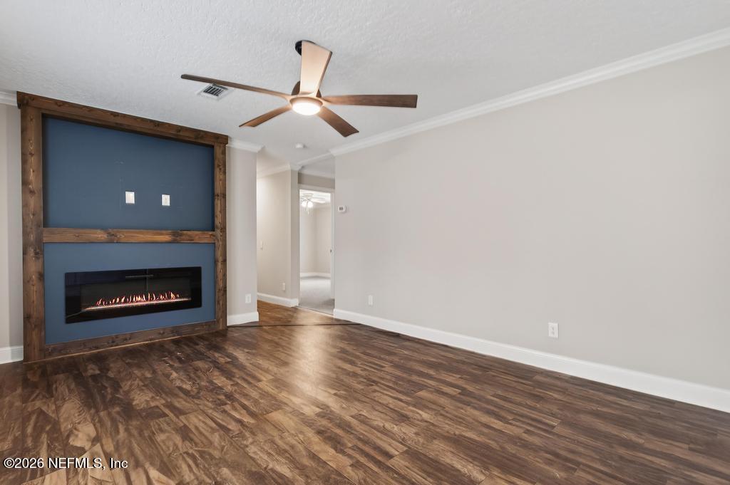 95605 Springhill Road Fernandina Beach, FL 32034 - Photo 23 of 62 a view of an empty room with wooden floor fireplace and a window