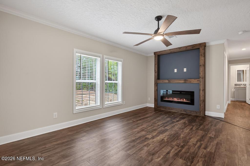 95605 Springhill Road Fernandina Beach, FL 32034 - Photo 27 of 62 a view of an empty room with wooden floor fireplace and a window