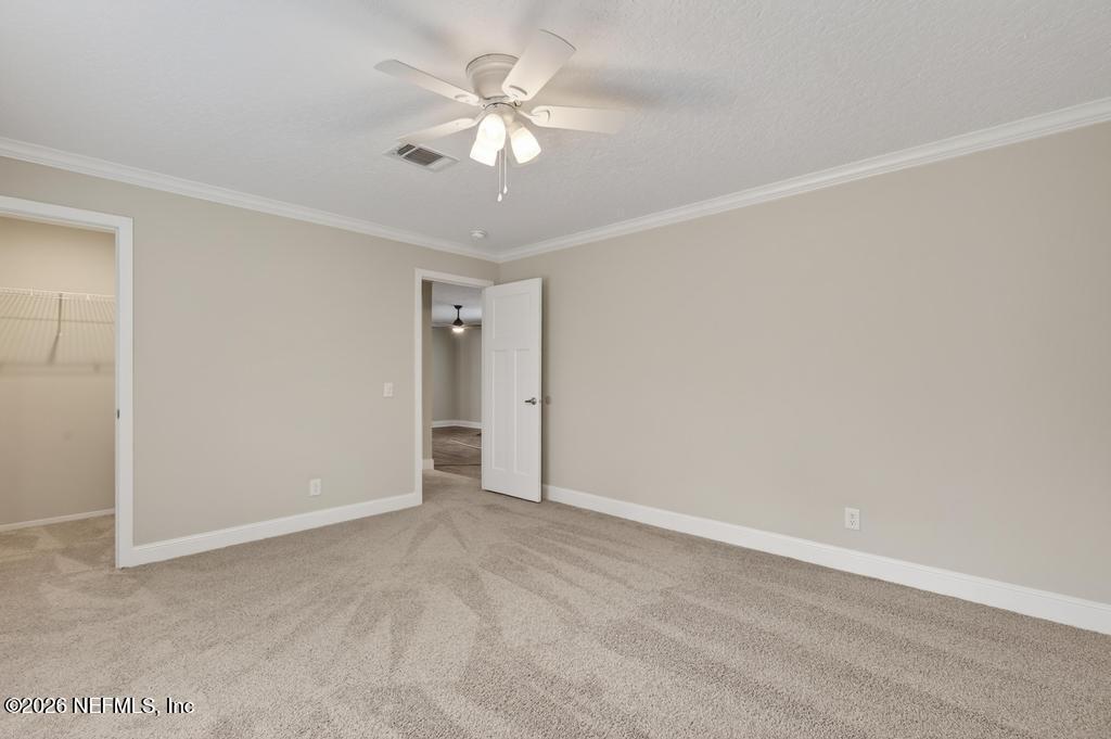 95605 Springhill Road Fernandina Beach, FL 32034 - Photo 29 of 62 an empty room with a ceiling fan and a window