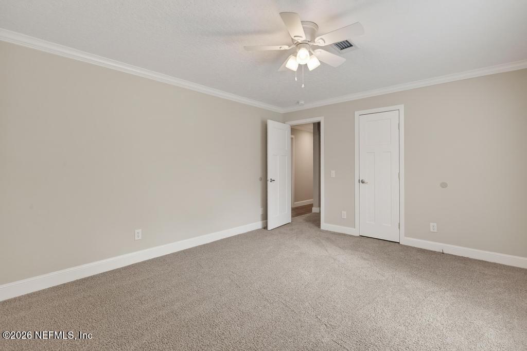 95605 Springhill Road Fernandina Beach, FL 32034 - Photo 46 of 62 an empty room with a ceiling fan and a window
