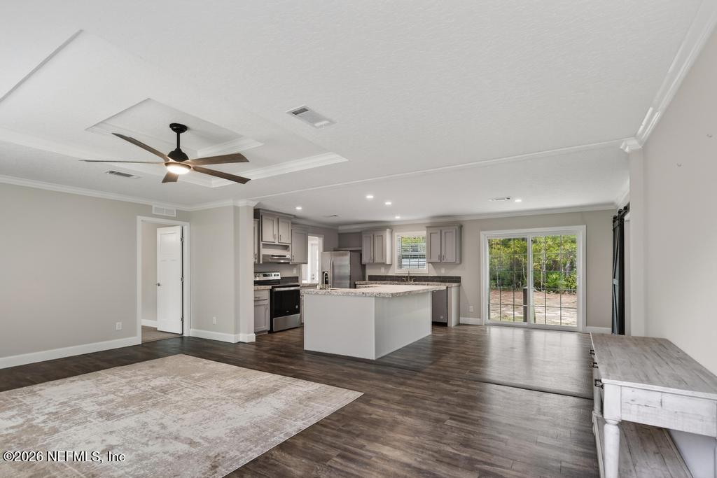 95605 Springhill Road Fernandina Beach, FL 32034 - Photo 8 of 62 a open kitchen with a stove a sink dishwasher and a fireplace with wooden floor