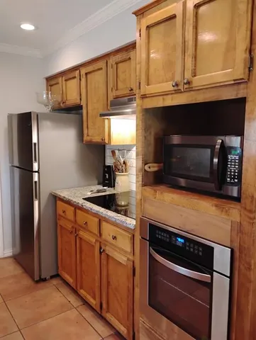 a kitchen with stainless steel appliances granite countertop a stove and a refrigerator