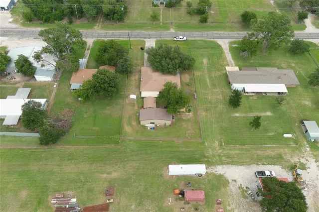 an aerial view of residential houses with outdoor space and lake view