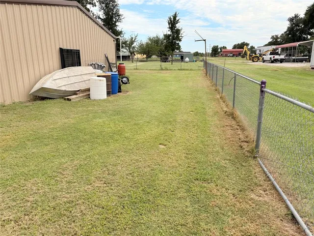 a view of a house with pool and a yard