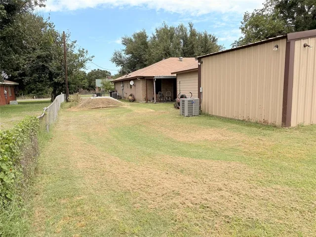 a backyard of a house with table and chairs