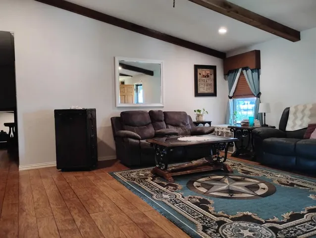 a living room with furniture and a rug