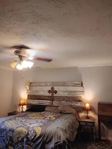 a bedroom with a bed and a chandelier