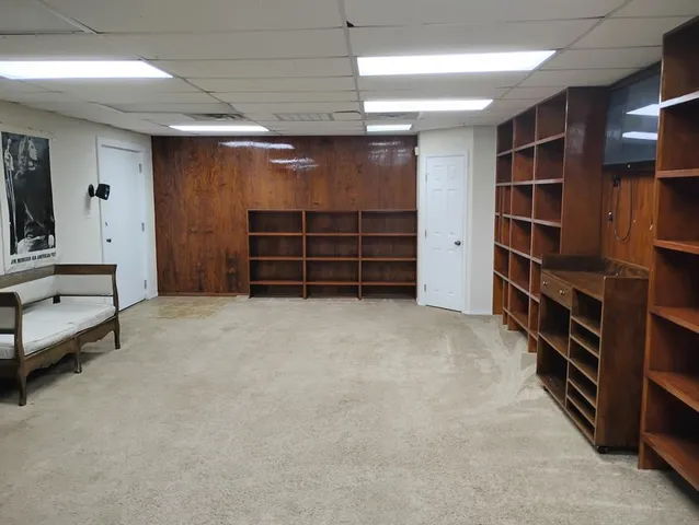 a view of an empty room with furniture and storage