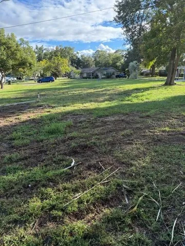 a view of a green field with lots of trees