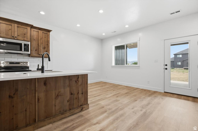 164 North 400 East Preston, ID 83263 - Photo 2 of 21 Open-concept living space featuring wood-finish flooring and recessed lighting