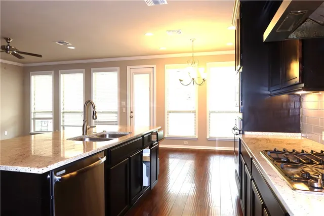 a kitchen with lots of counter top space and wooden floor