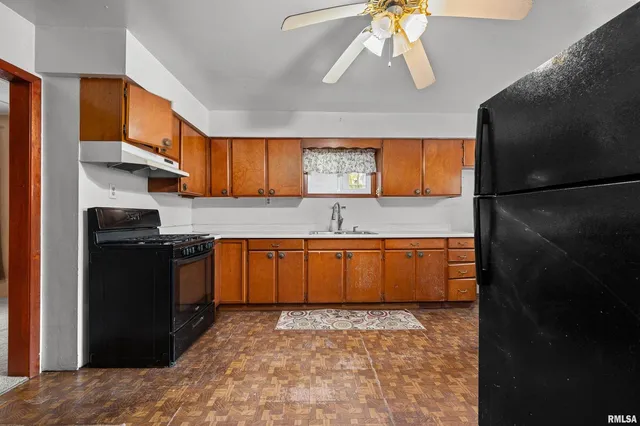 a kitchen with stainless steel appliances granite countertop a refrigerator a sink a stove and island