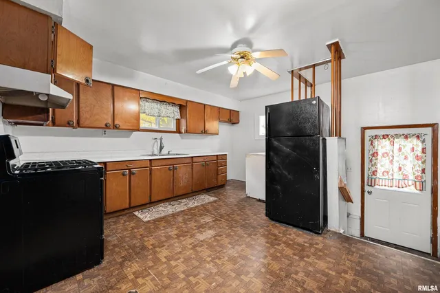 a kitchen with stainless steel appliances granite countertop a sink a stove and a refrigerator