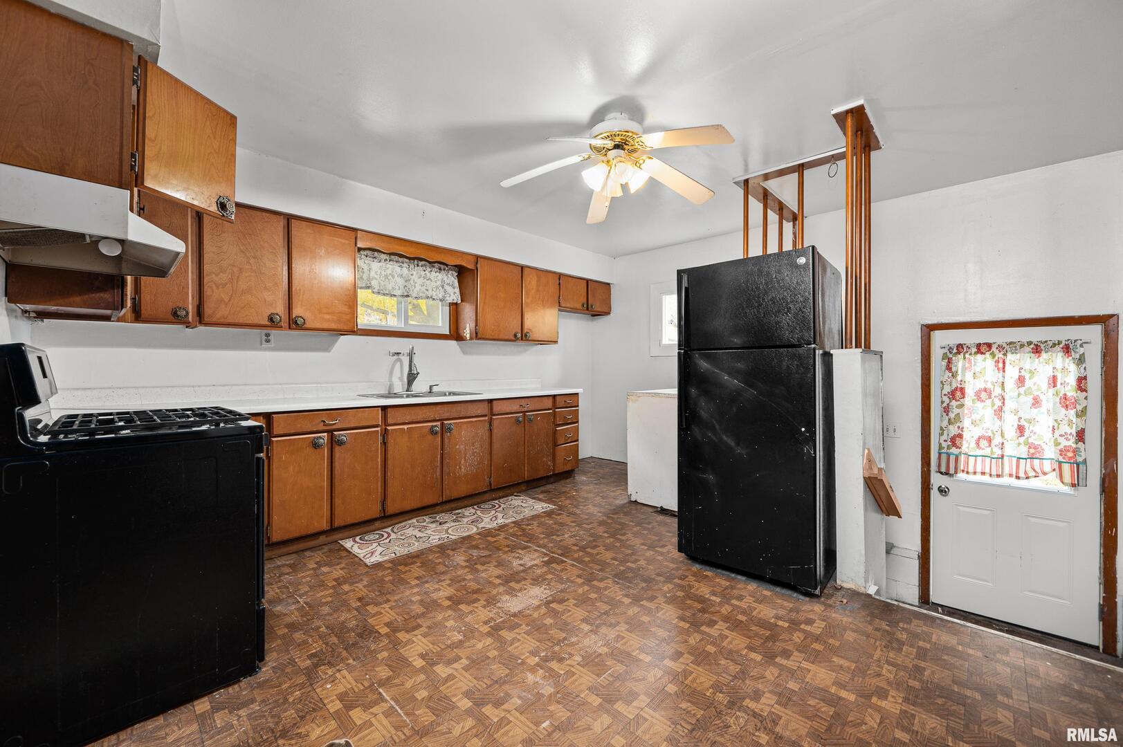 158 5th Street Silvis, IL 61282 - Photo 14 of 23 a kitchen with stainless steel appliances granite countertop a refrigerator a sink a stove and island