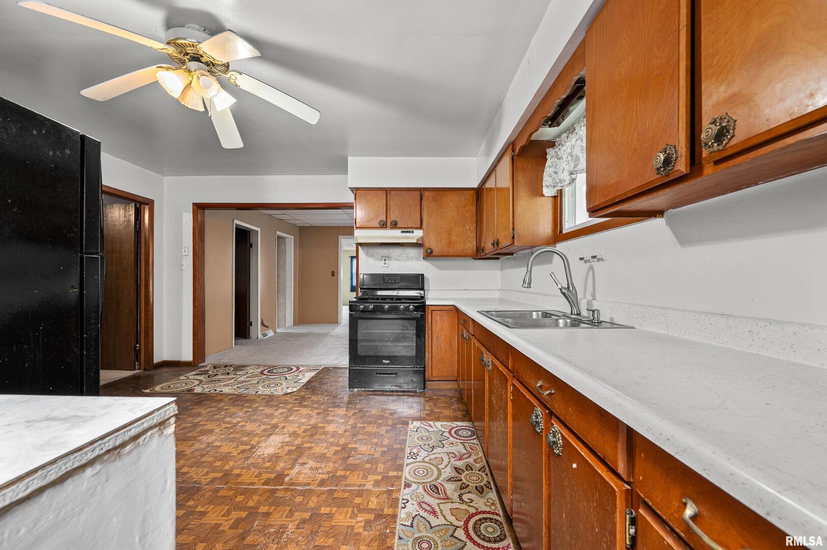 158 5th Street Silvis, IL 61282 - Photo 15 of 23 a kitchen with stainless steel appliances granite countertop a sink a stove and a refrigerator