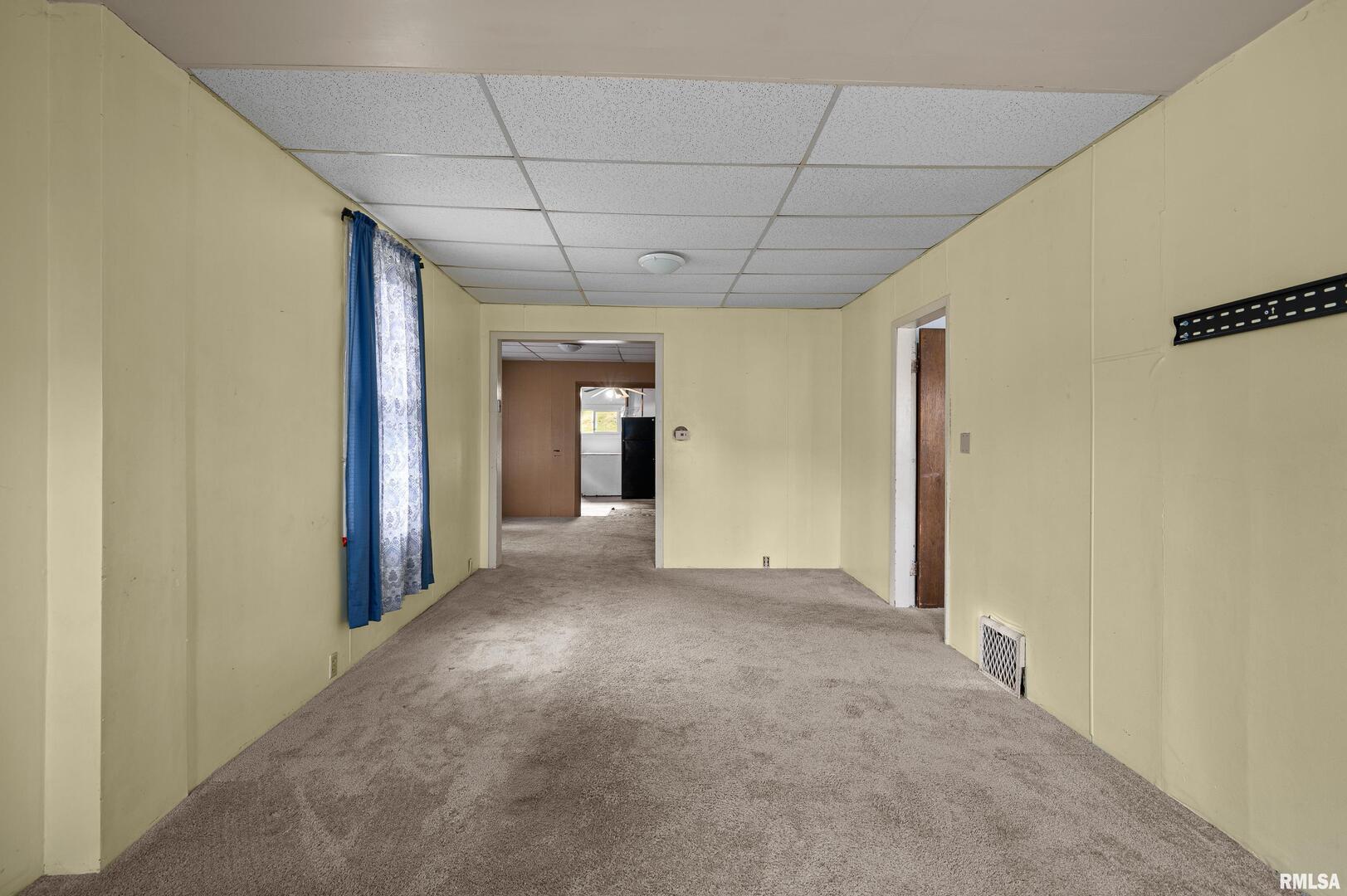 158 5th Street Silvis, IL 61282 - Photo 4 of 23 a view of a livingroom with an empty space and a hallway