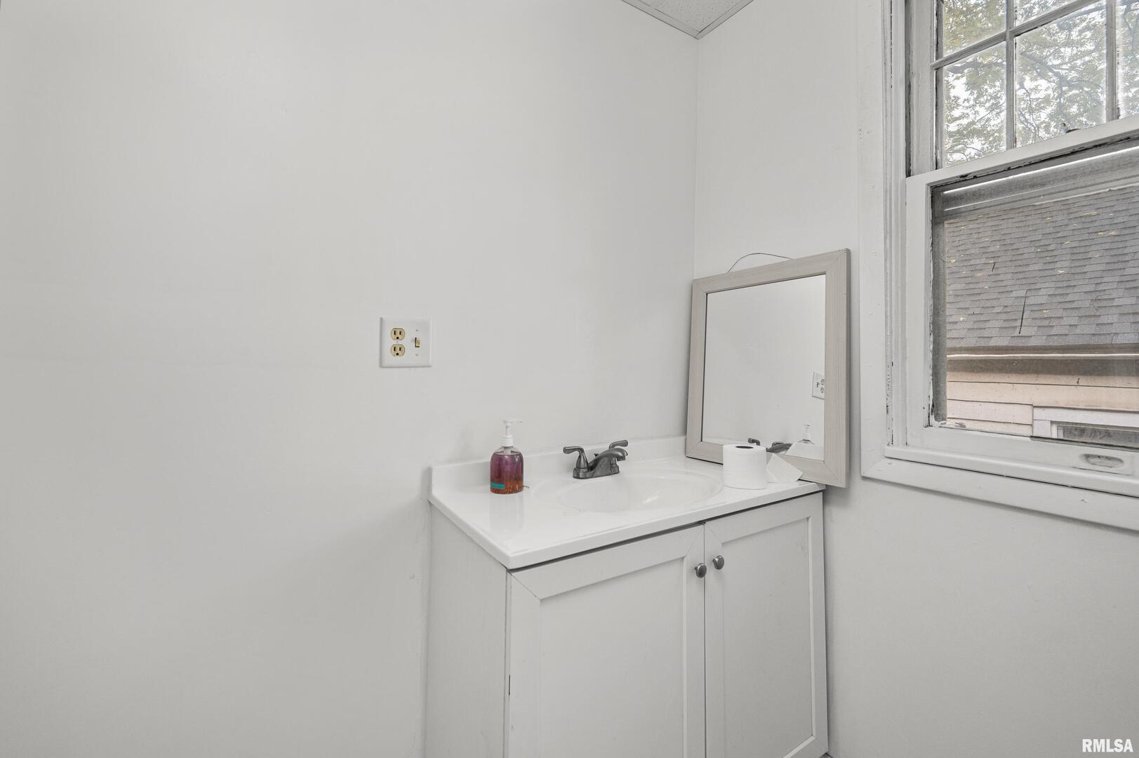 158 5th Street Silvis, IL 61282 - Photo 9 of 23 a bathroom with a sink and a vanity
