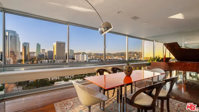 a dining room with furniture and a floor to ceiling window