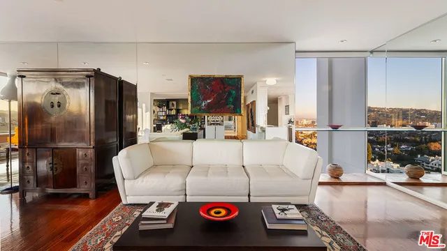 a utility room with stainless steel appliances furniture and a kitchen view