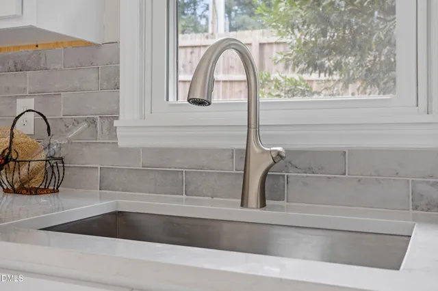a kitchen with a microwave and potted plant