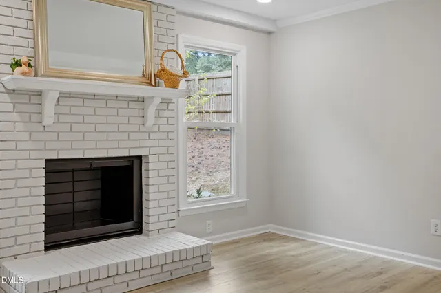 a living room with a fireplace and a wooden floor