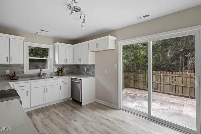 a kitchen with wooden cabinets and white appliances