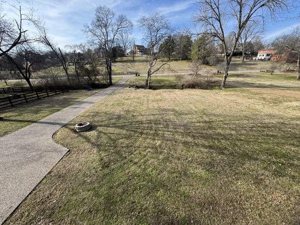 a front view of house with yard and trees around