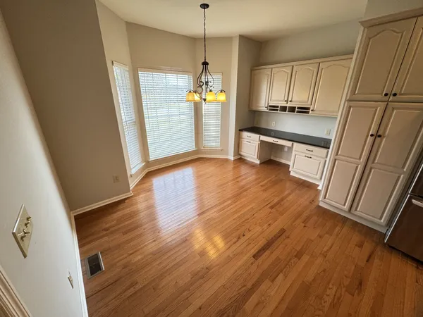 a kitchen with wooden floors and appliances