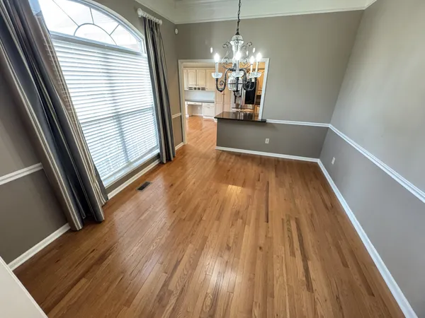 a view of a room wooden floor an entryway