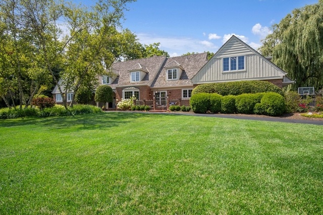 575 Turicum Road Lake Forest, IL 60045 - Photo 1 of 22 a front view of a house with a yard and garage