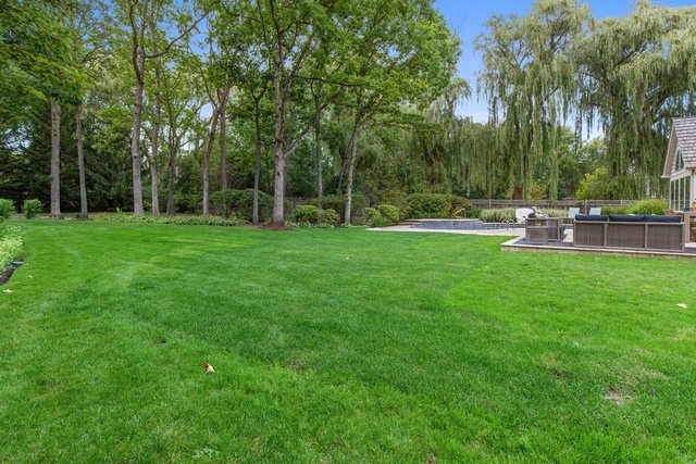 575 Turicum Road Lake Forest, IL 60045 - Photo 21 of 22 a view of a backyard with a garden and trees