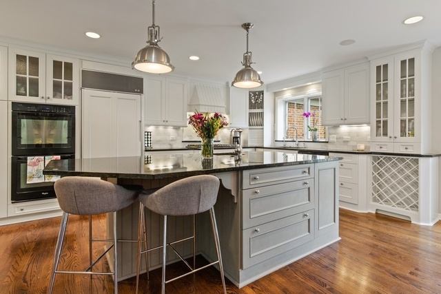575 Turicum Road Lake Forest, IL 60045 - Photo 6 of 22 a kitchen with granite countertop kitchen island white cabinets and a chandelier