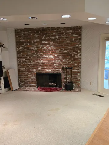 an empty room with fireplace