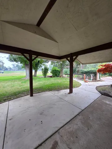 a view of a patio with a backyard