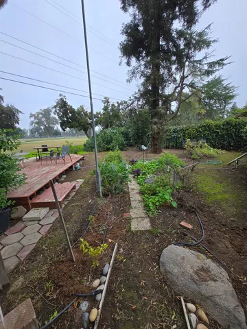 a backyard of a house with table and chairs