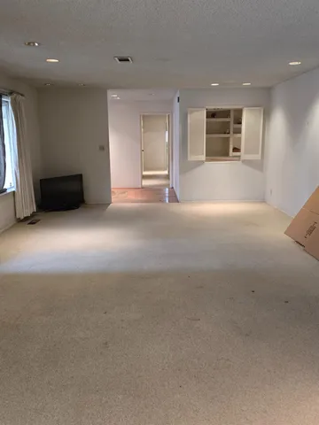 a view of an empty room with a window