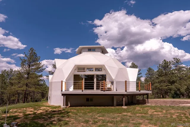 a large building with a big yard and large trees