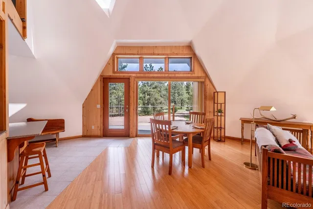 a dining room with furniture and wooden floor