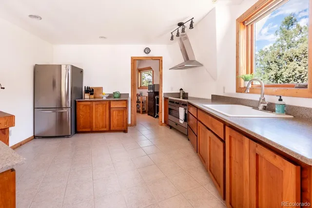 a kitchen with stainless steel appliances granite countertop refrigerator and a sink