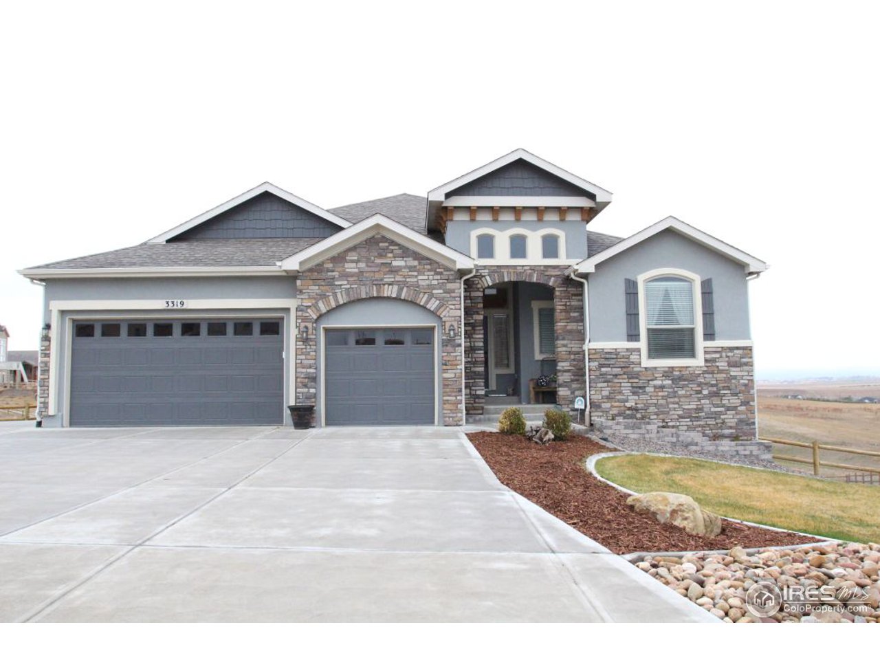 3319 Tranquility Way Berthoud, CO 80513 - Photo 1 of 40 a front view of a house with a yard and garage