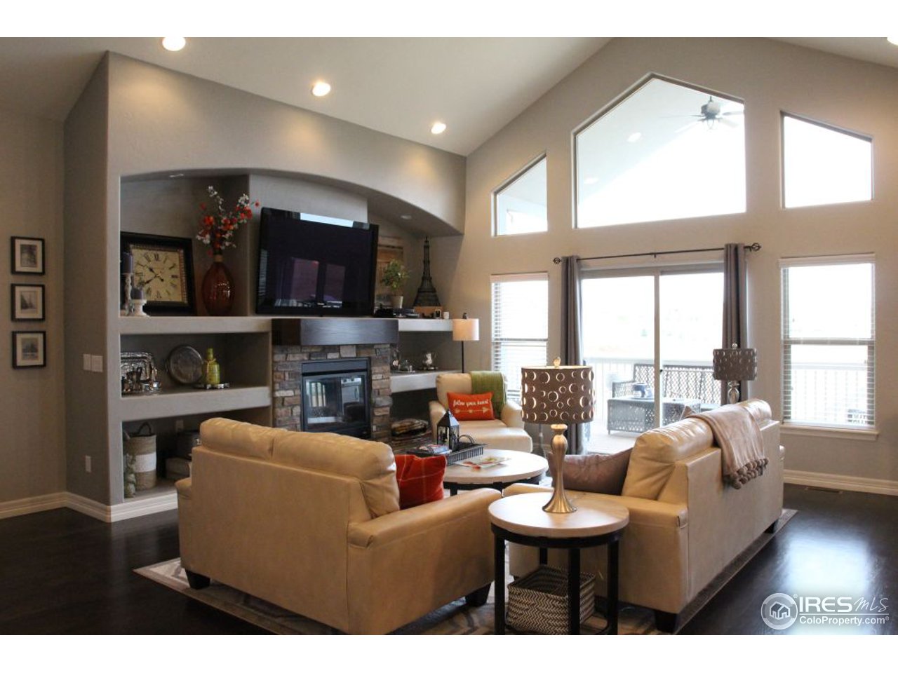 3319 Tranquility Way Berthoud, CO 80513 - Photo 11 of 40 a living room with furniture a flat screen tv and a large window