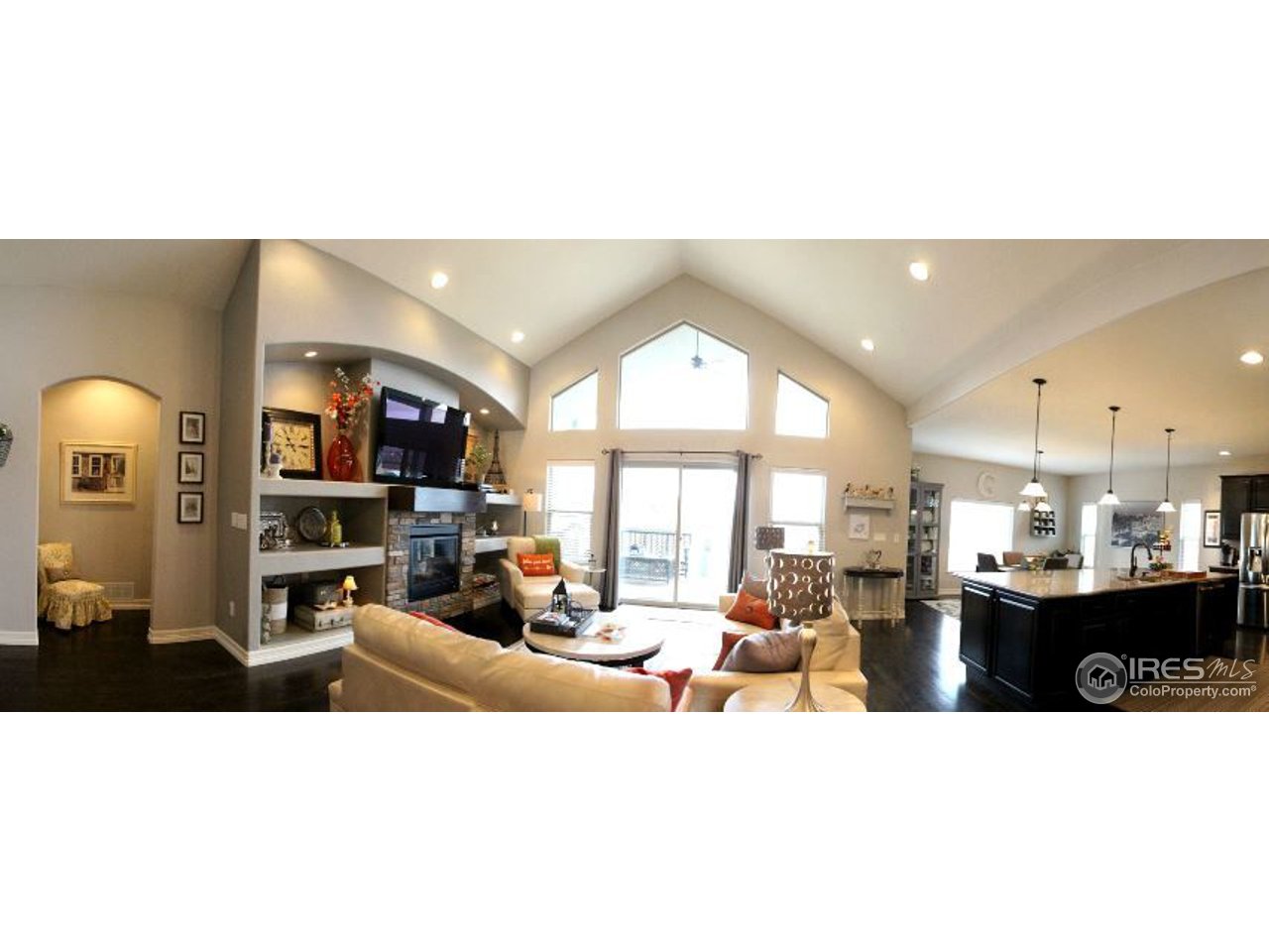 3319 Tranquility Way Berthoud, CO 80513 - Photo 12 of 40 a living room with lots of furniture and kitchen view
