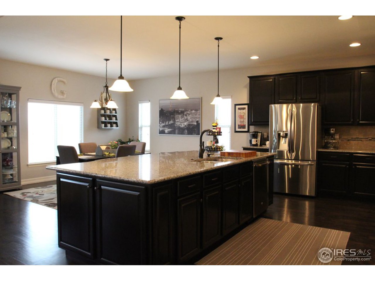 3319 Tranquility Way Berthoud, CO 80513 - Photo 16 of 40 a kitchen with stainless steel appliances granite countertop a sink a stove and a refrigerator