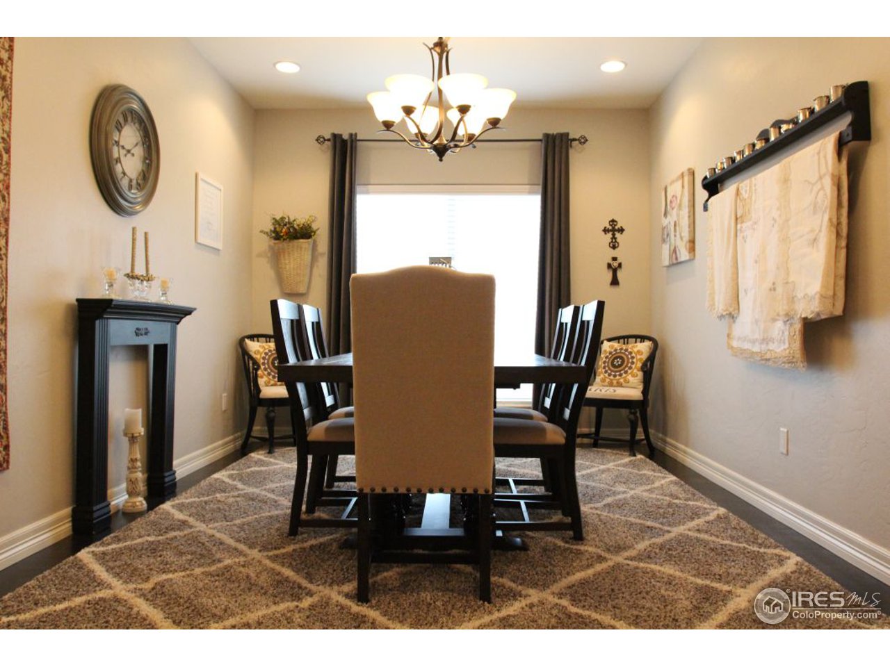 3319 Tranquility Way Berthoud, CO 80513 - Photo 19 of 40 a view of a dining room with furniture and a chandelier