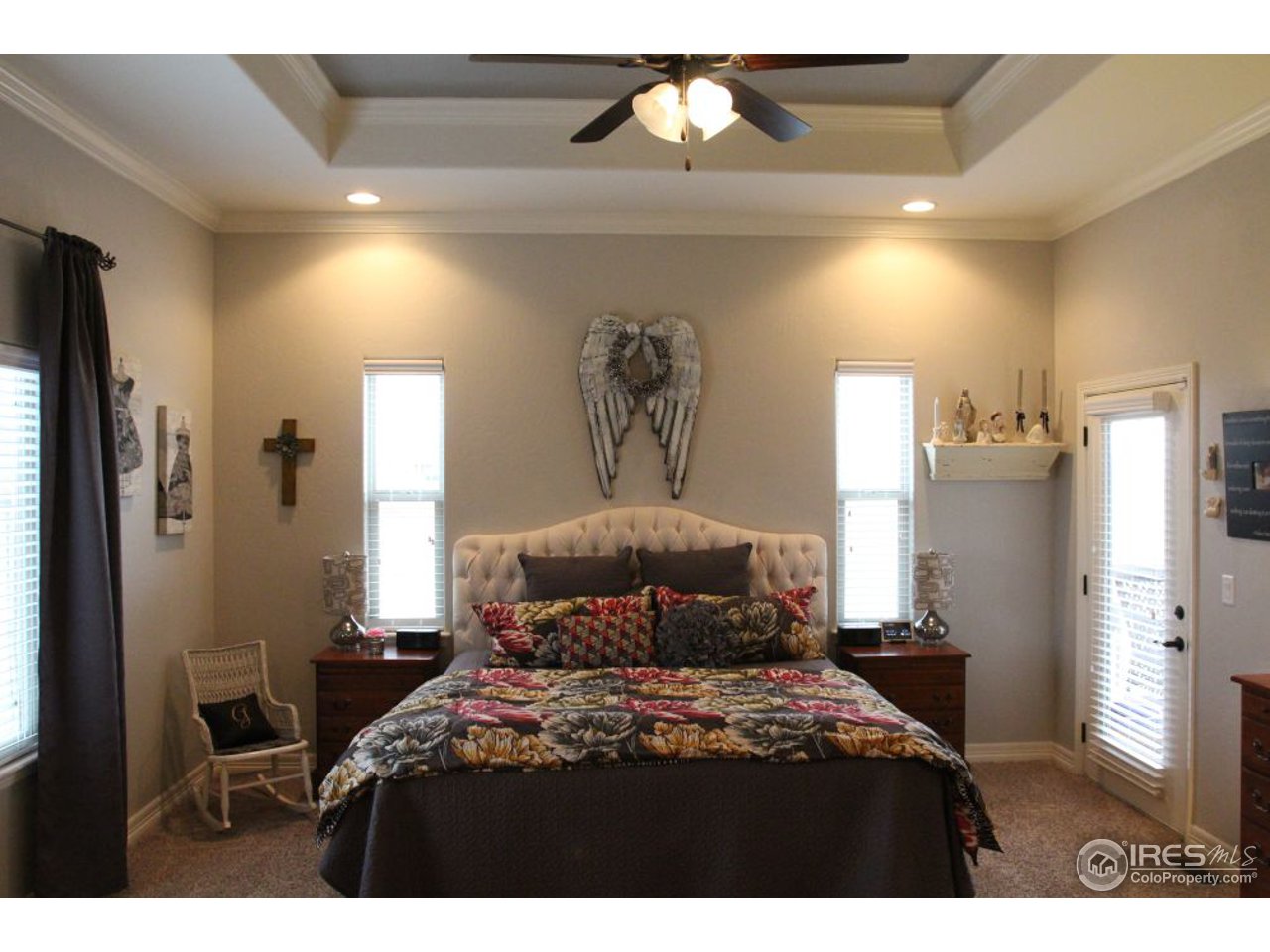 3319 Tranquility Way Berthoud, CO 80513 - Photo 22 of 40 a bedroom with a bed and a chandelier