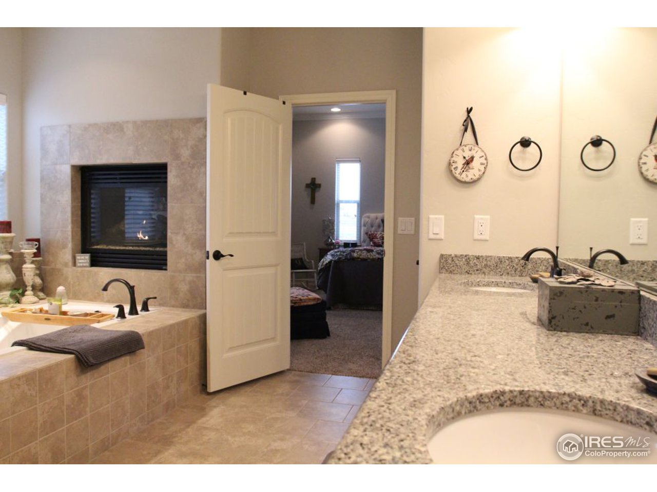 3319 Tranquility Way Berthoud, CO 80513 - Photo 23 of 40 a en suite bathroom with a sink and a mirror
