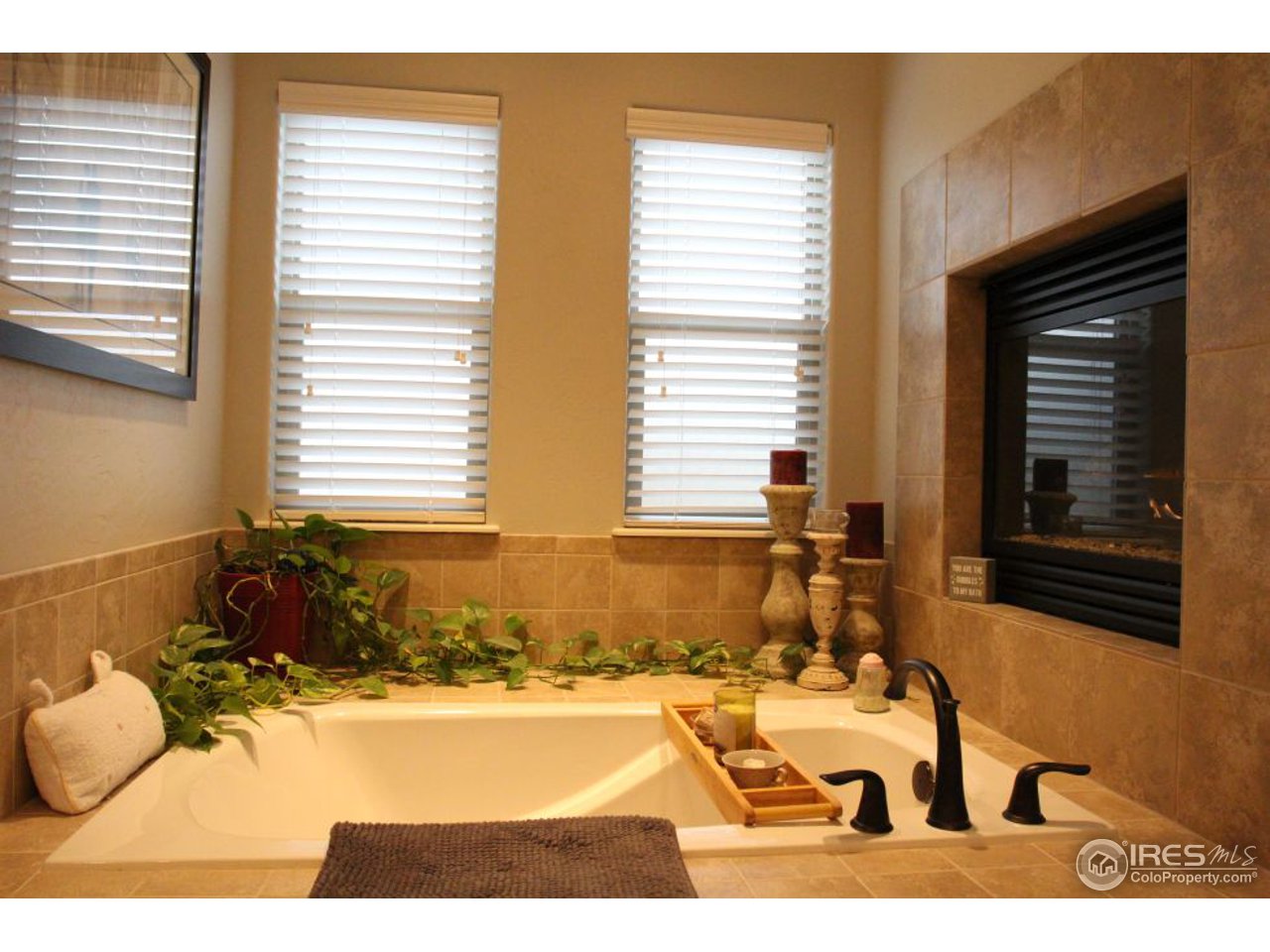 3319 Tranquility Way Berthoud, CO 80513 - Photo 25 of 40 a bathroom with a bathtub and next to a window