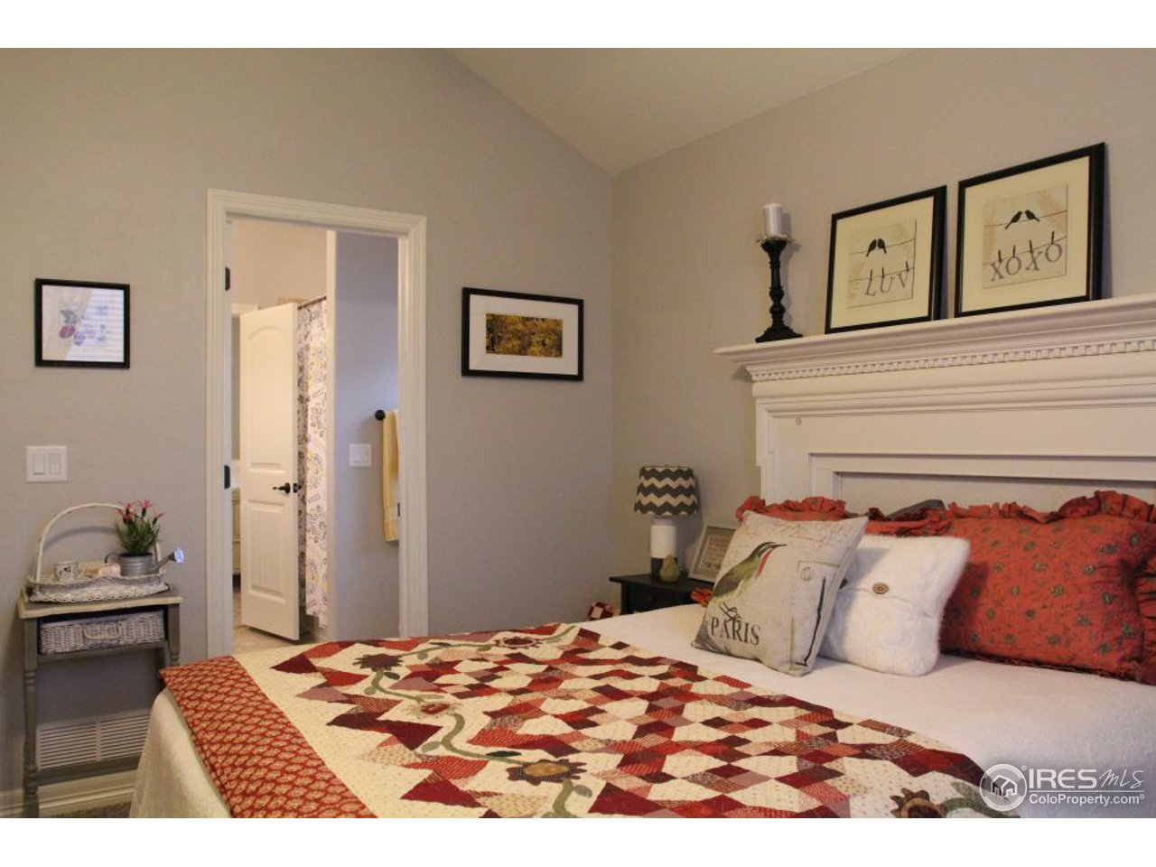 3319 Tranquility Way Berthoud, CO 80513 - Photo 27 of 40 a bedroom with a bed and painting on the wall
