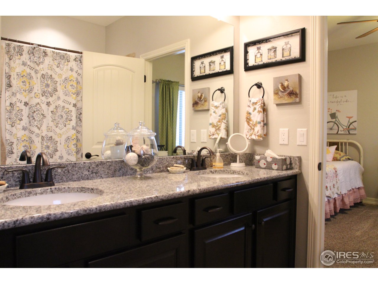 3319 Tranquility Way Berthoud, CO 80513 - Photo 29 of 40 a bathroom with double vanity sinks a mirror and a shower