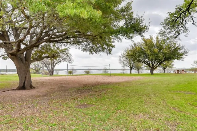 a view of pool of grass and trees